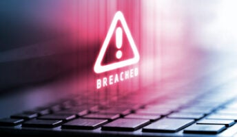 Red alert logo on laptop computer screen showing data breach