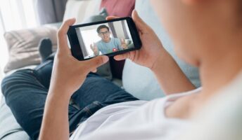 man calling a colleague on sofa