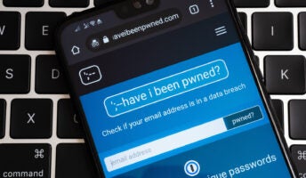 Data breach notification site "Have I been pwned" open on smartphone against keyboard background
