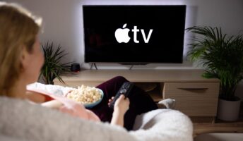 Woman watching AppleTV on television