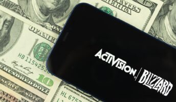 Activision Blizzard logo against piles of dollars