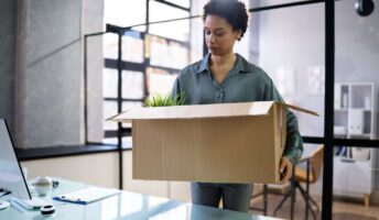 Female laid off employee collecting items