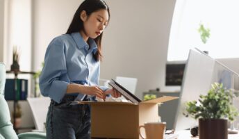 Women packing up her office equipment