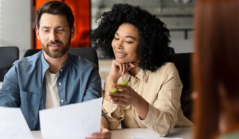 Women and man looking at a sheet of paper