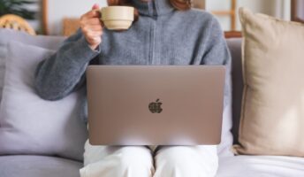 Person working from home with a Mac laptop