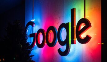 Google's office logo lit up at night