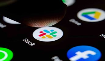 Slack logo on a smartphone screen with finger about to press