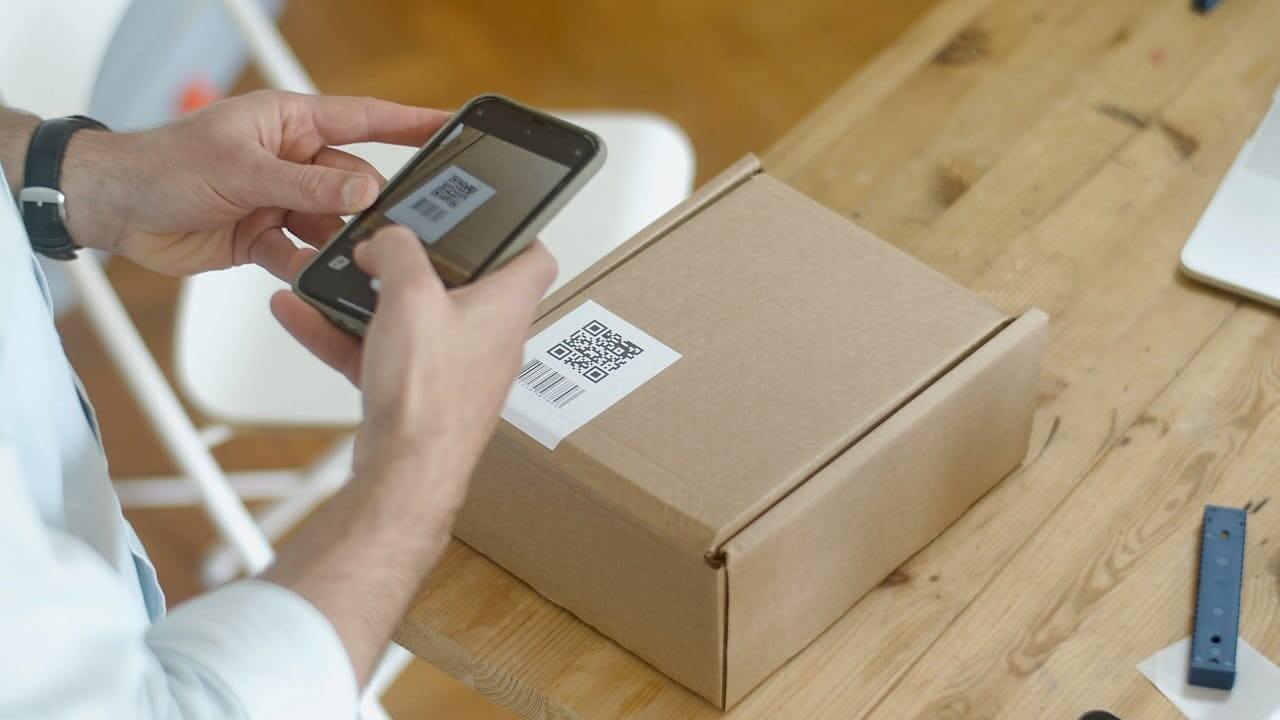 A QR code being scanned by a mobile phone.