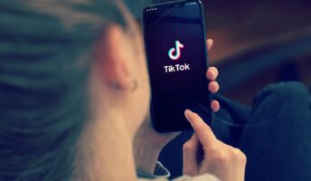 girl looking at tiktok on her phone