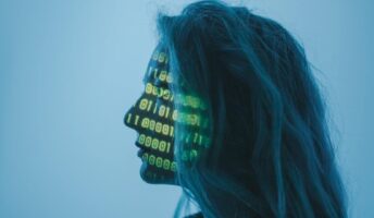 A woman with binary code projected across her face.