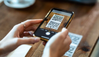 Customer scanning QR code to order food at the table